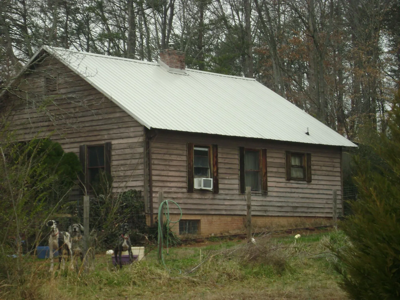 White metal roof on an old wood sided farmhouse, from a Metal Roof Installation job in Orient